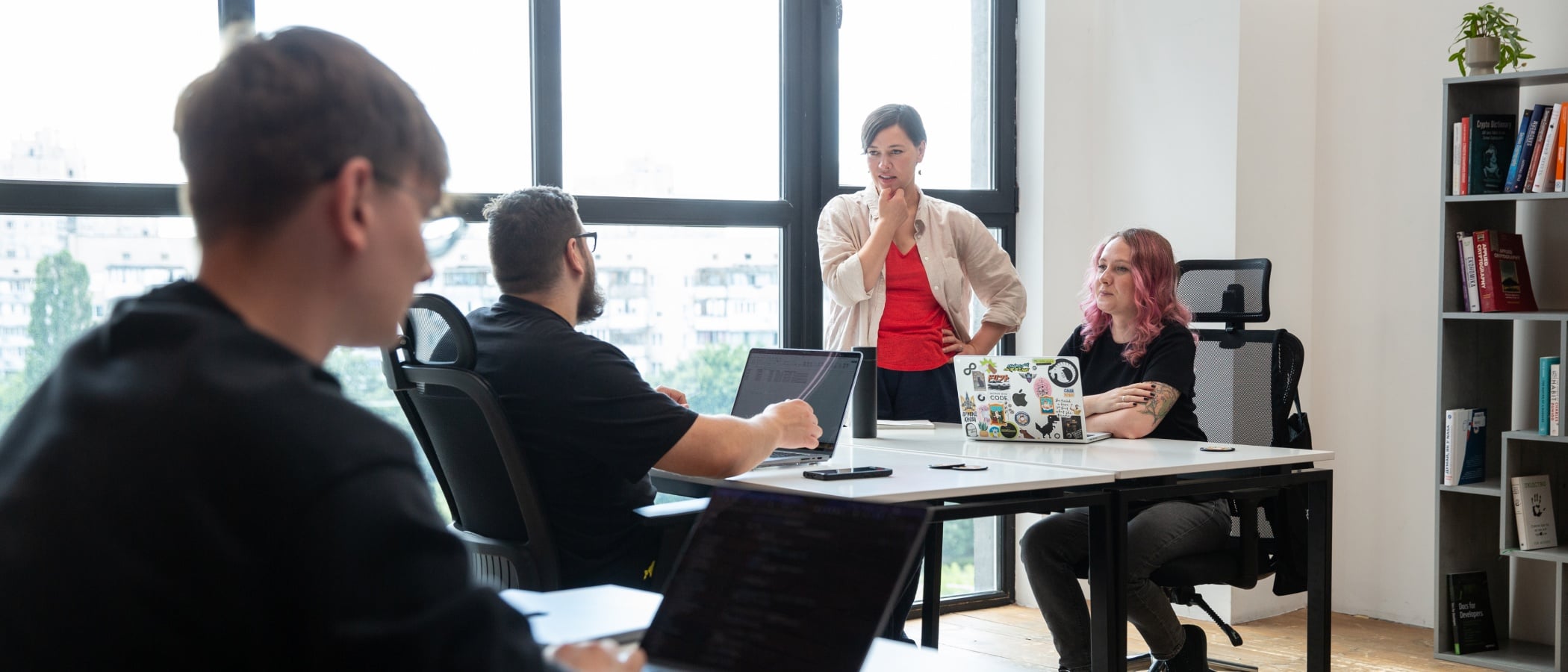 HR Generalist talking with colleagues during an office meeting