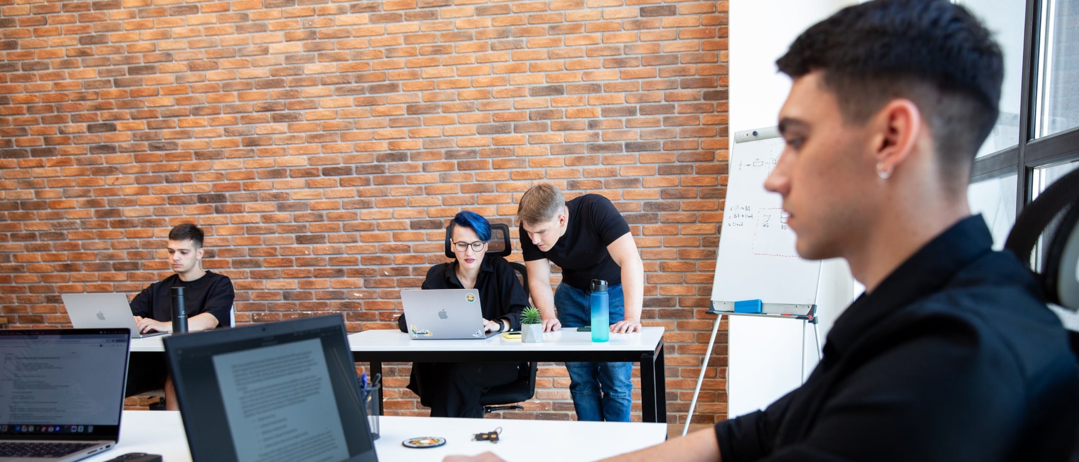 Cossack Labs team members collaborating during discussion